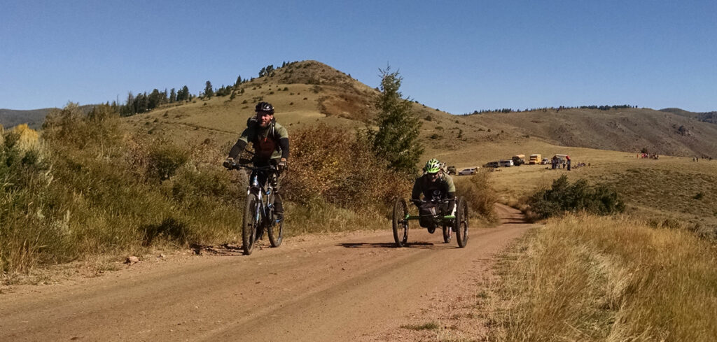 Riding a hand cycle downhill.